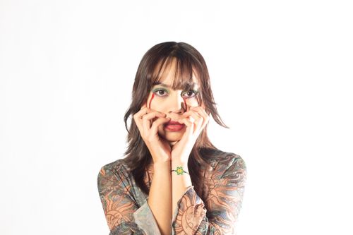 Free Creative portrait featuring a young woman with intricate makeup and artistic expression. Stock Photo