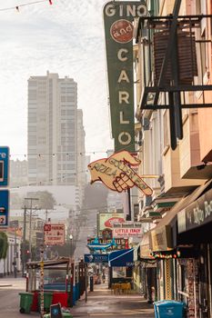 Colorful street view of Little Italy, showcasing iconic signage and urban architecture in San Francisco.