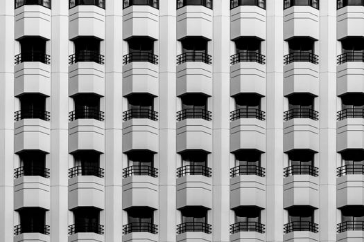 Black and white photo of symmetrical building facades with geometric balconies.