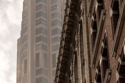 Urban architectural contrast between ornate facade and modern skyscraper design.