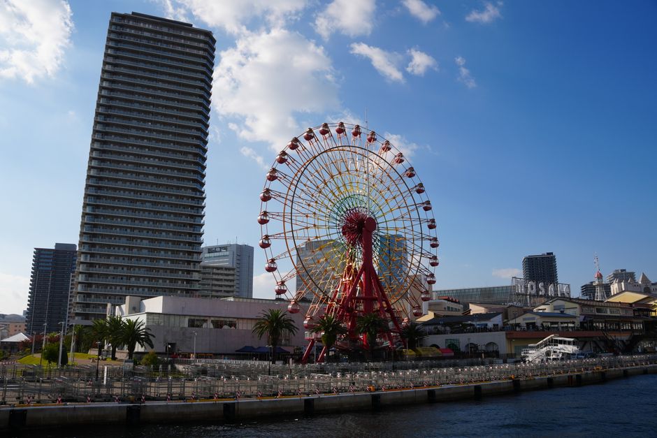 Scenic view of Kobe's iconic Harborland Ferris Wheel on a sunny day.