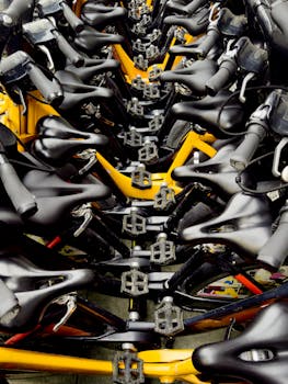 Overhead view of bicycles tightly packed in an urban bike rack, highlighting handlebars and pedals.