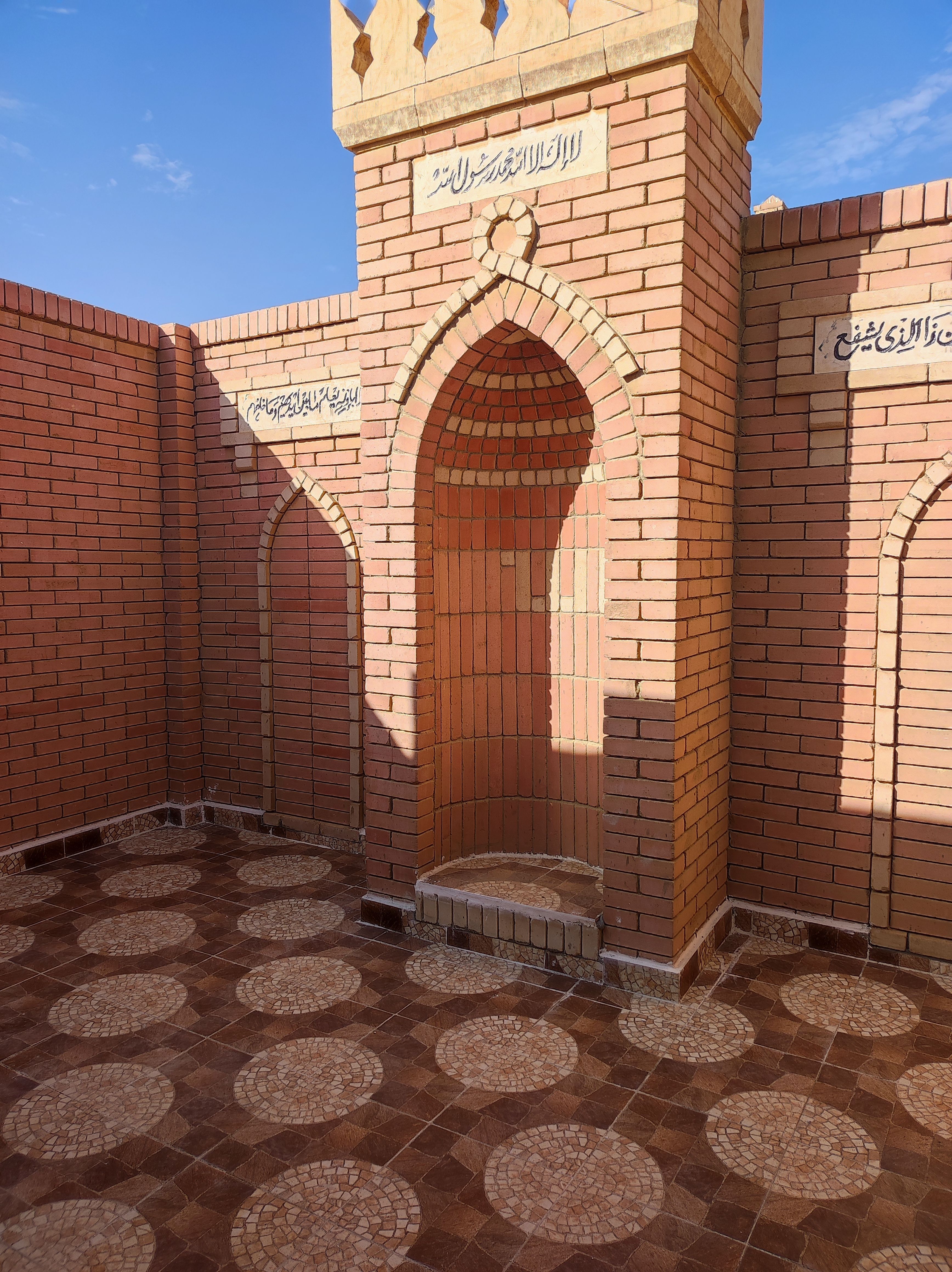 A brick wall with traditional Islamic architecture detail in Cairo, Egypt, showcasing intricate archways.