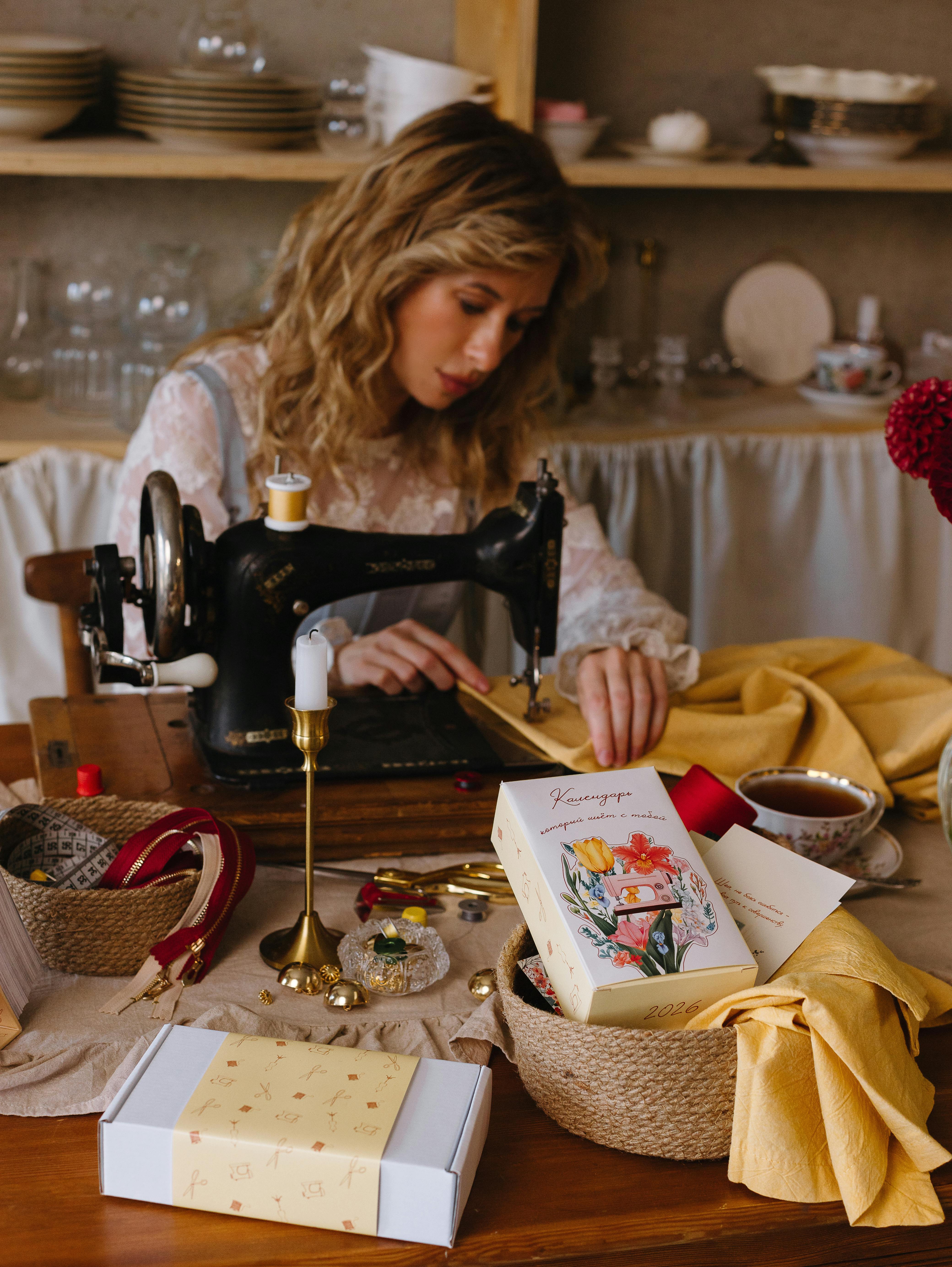 A woman sewing with a vintage machine in a cozy, well-decorated workshop atmosphere.