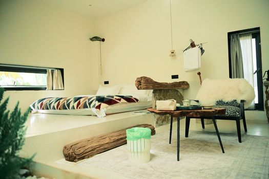 Stylish contemporary bedroom featuring rustic wooden elements and cozy textiles, ideal for interior design inspiration.