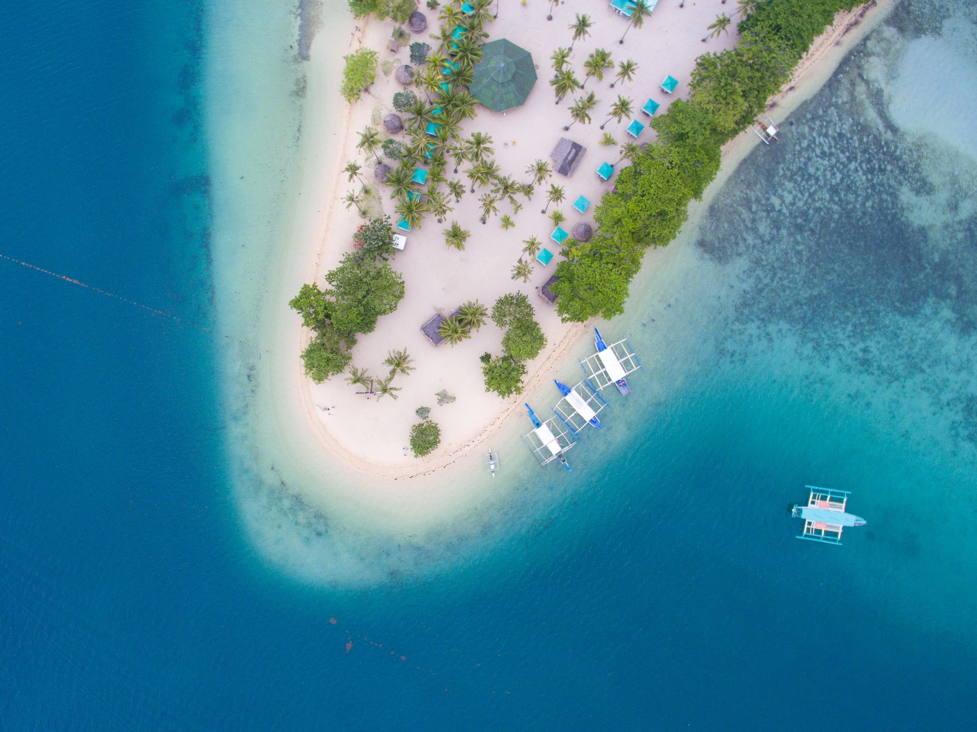 Stunning aerial view of a tropical island with turquoise waters in the Philippines.