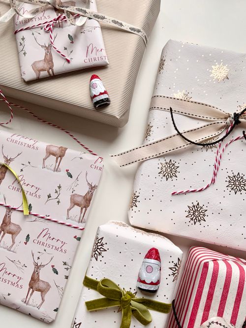 Free Beautifully wrapped Christmas gifts with festive paper and decorations. Stock Photo