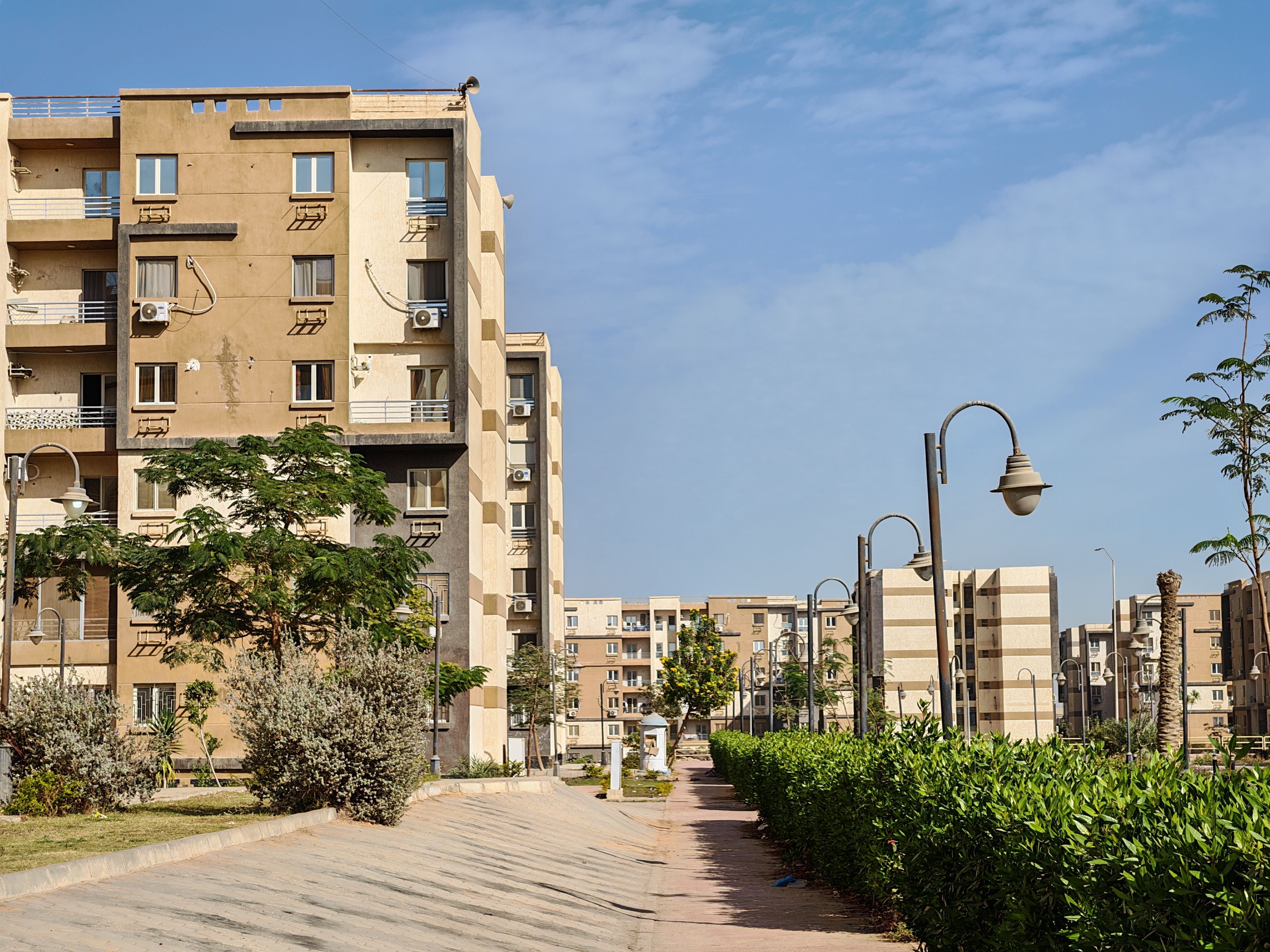 Modern residential neighborhood with apartment buildings and greenery to evaluate before relocating