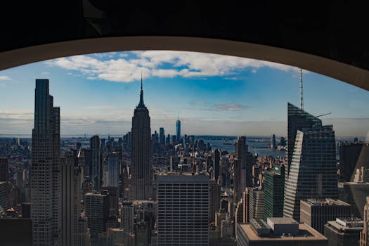 Stunning view of New York City's skyline featuring the Empire State Building under a bright daytime sky.