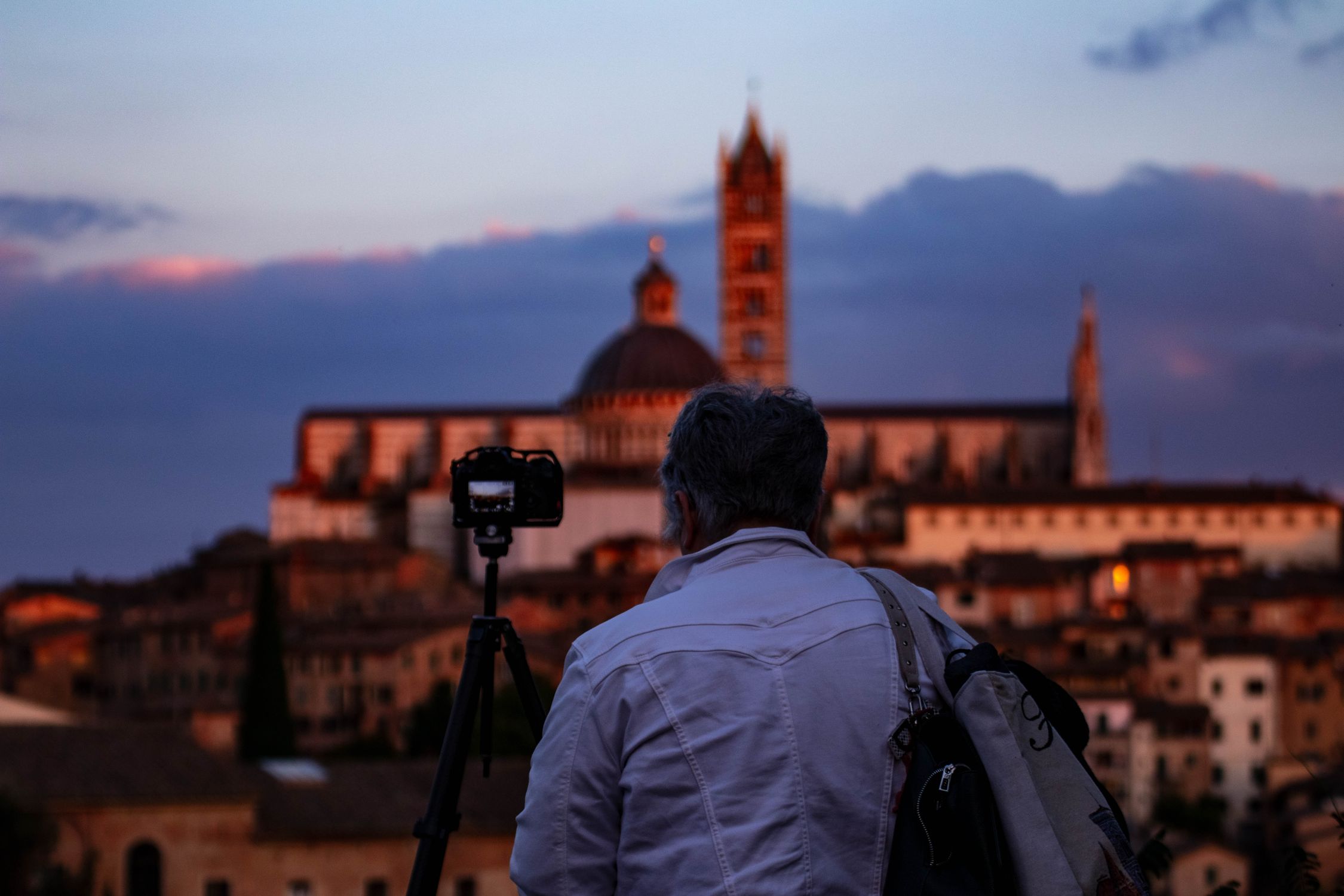 Photographer Capturing Siena Skyline at Dusk · Free Stock Photo