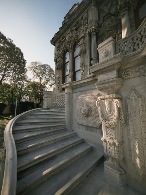 Free Elegant historical facade with intricate carvings and curved staircase. Stock Photo
