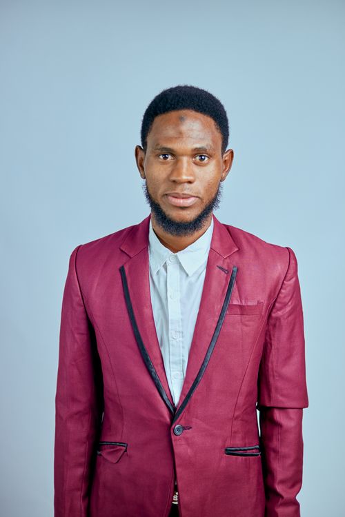 Free Professional portrait of a young man in a sharp red suit, ideal for business or fashion use. Stock Photo