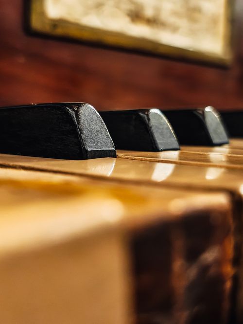 Free Detailed close-up view of vintage piano keys showcasing texture and warm tones, perfect for music and art themes. Stock Photo