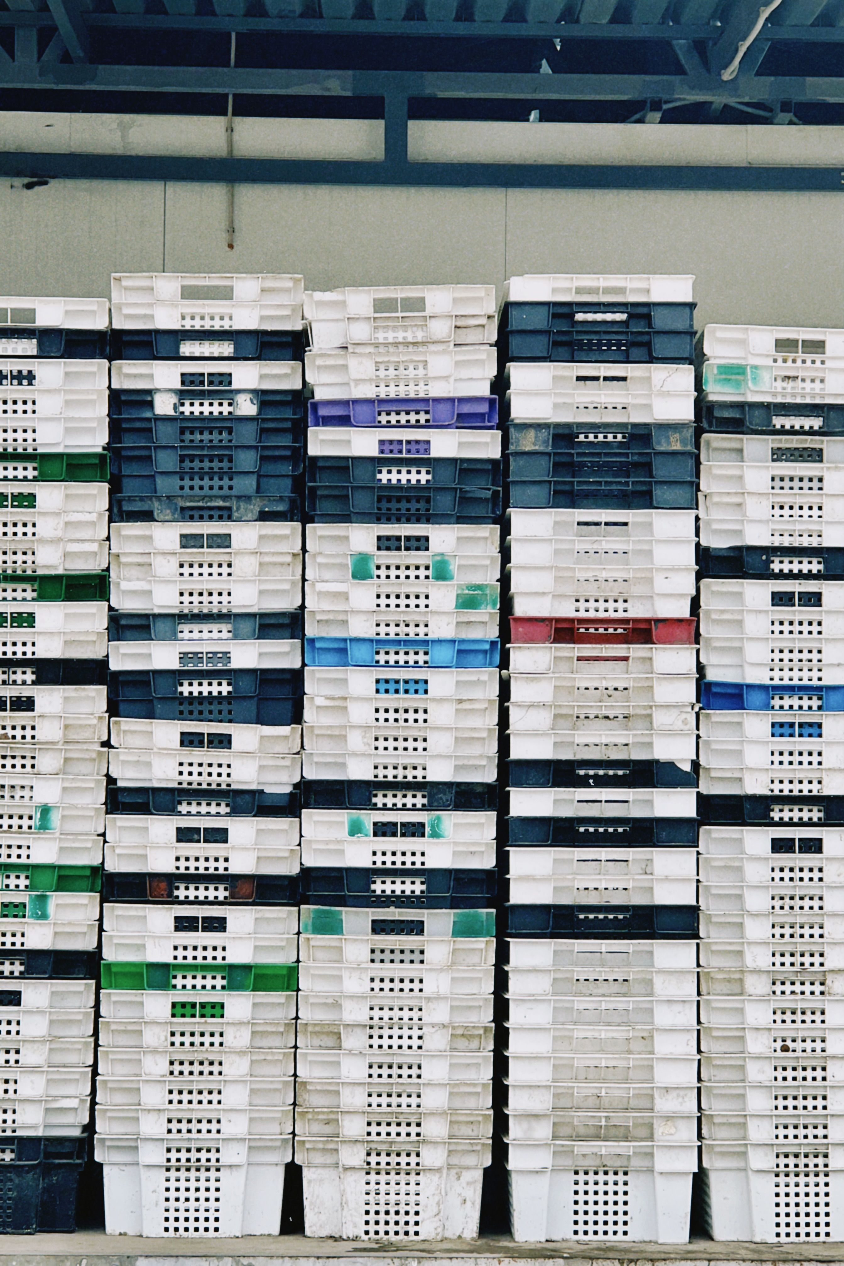 Organized stacks of reusable plastic crates in a warehouse