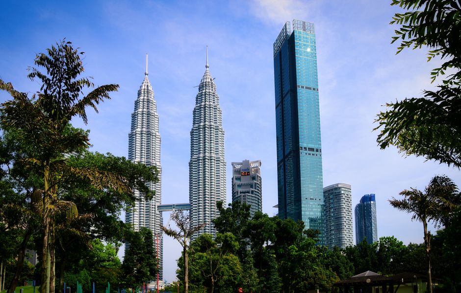 Stunning view of Petronas Twin Towers and modern skyscrapers in Kuala Lumpur, Malaysia.