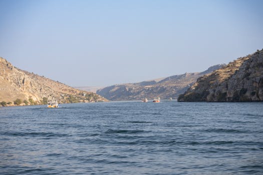 Beautiful landscape of the Euphrates River in Halfeti, Türkiye with boats and hills.