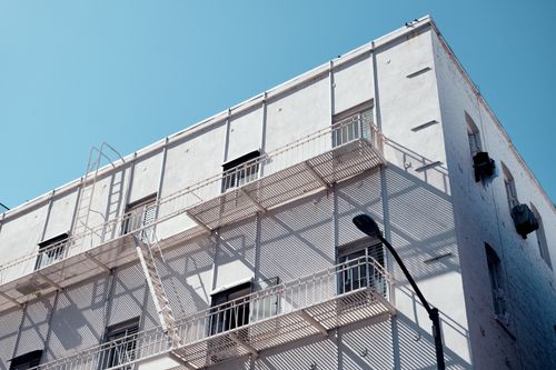 Free Modern building exterior with fire escapes, located in San Francisco under a clear blue sky. Stock Photo