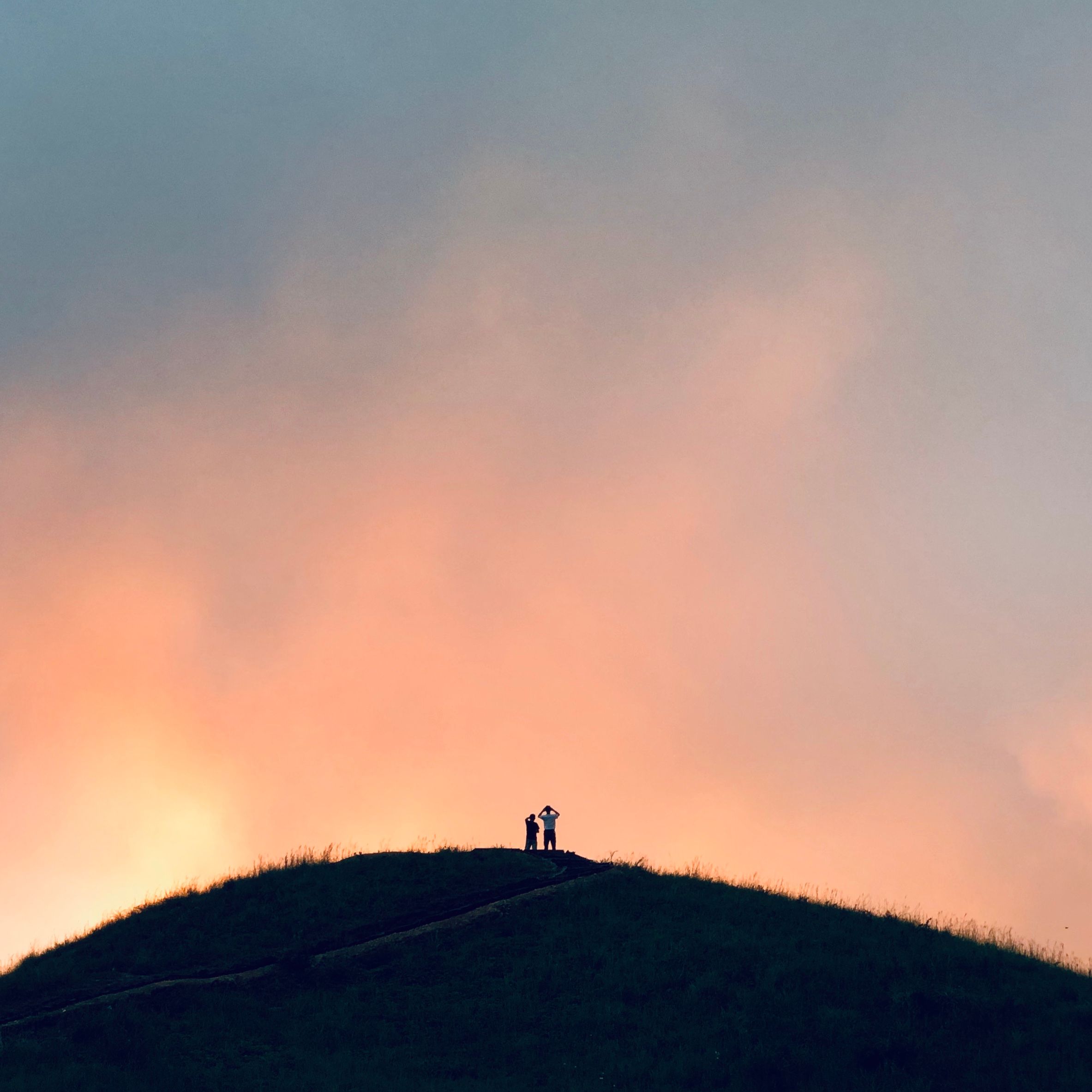 Soldiers' silhouettes on a hillside at dusk