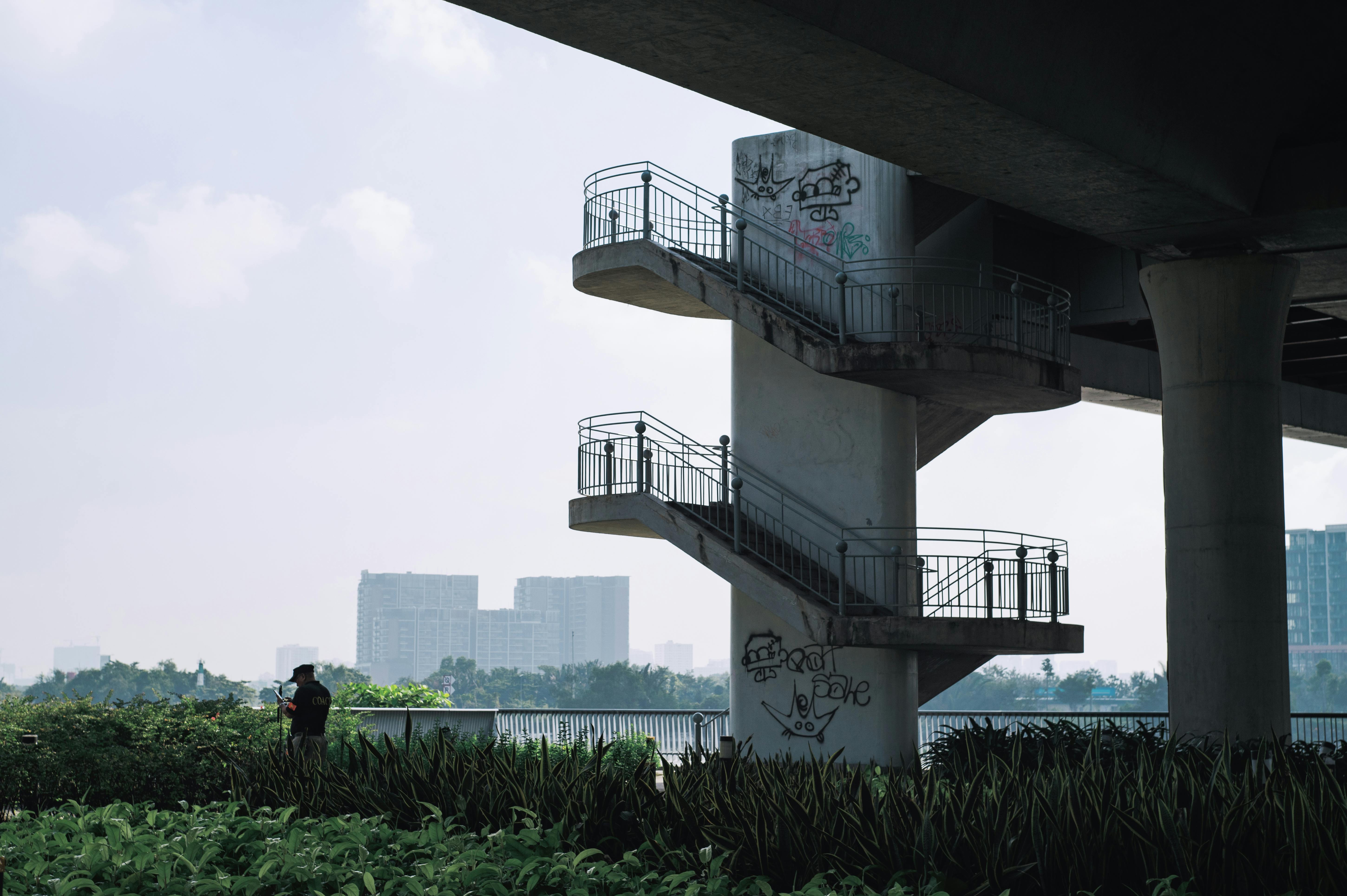 Quiet underpass with graffitied staircase in Ho Chi Minh City.