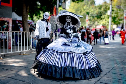 Colorful Catrina costumes at Dia de los Muertos festival in Mexico City.
