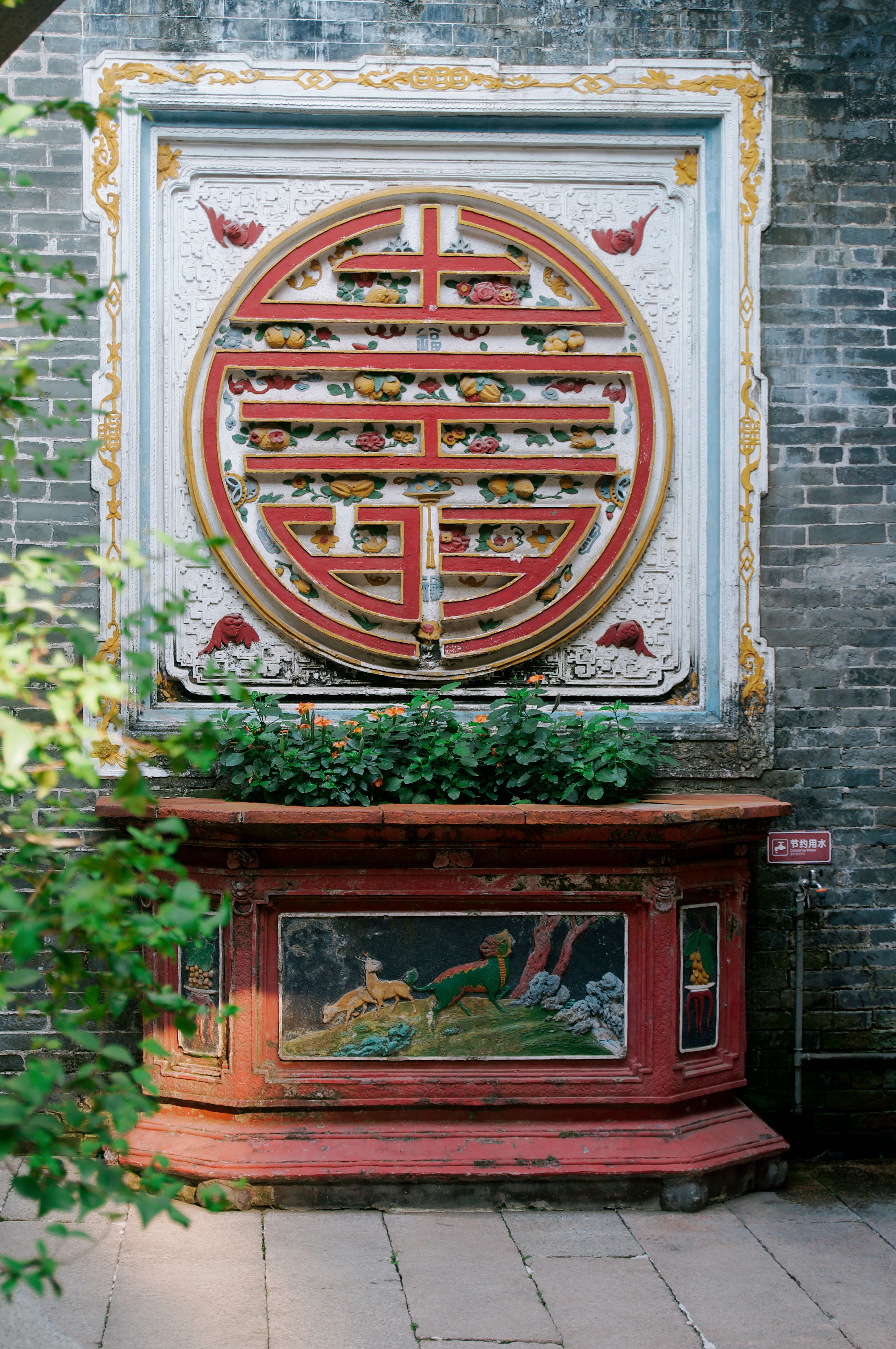 Intricate Chinese Architectural Decor on Brick Wall · Free Stock Photo
