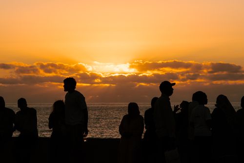 Free A vibrant sunset silhouette of people by the ocean in Rabat, capturing the lively atmosphere. Stock Photo