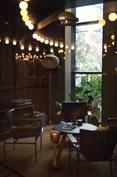 Elegant modern lounge featuring stylish furniture and soft lighting, perfect for relaxation.