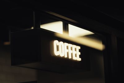 A sleek, minimalistic coffee shop sign illuminated in soft ambient lig — Photo by Valentin Ilas on Pexels