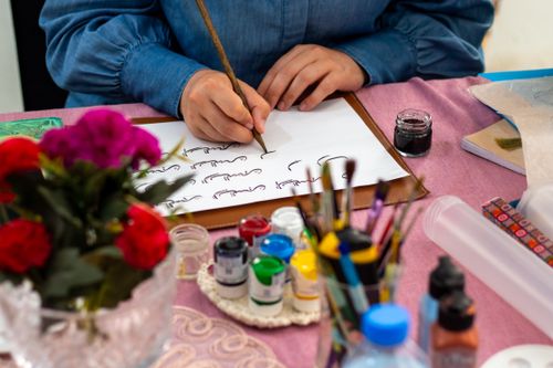 Calligraphy on paper with coloured ink and brushes — photo by Sedanur Kunuk on Pexels