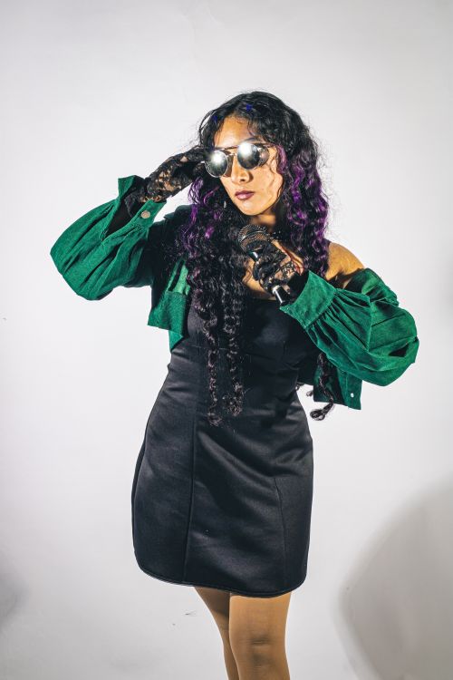 Free Fashionable woman in bold outfit posing with attitude, highlighting modern style and creativity. Stock Photo