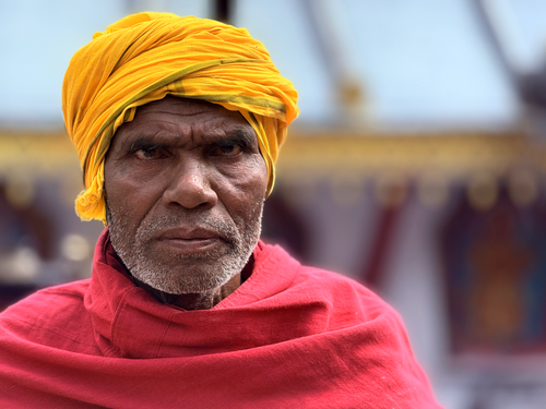 Free Intense portrait of a man in Kathmandu wearing vibrant traditional clothing. Stock Photo