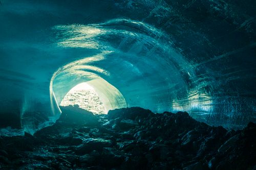 Free Explore the enchanting entrance of an ice cave, showcasing stunning blue tones and glacial textures. Stock Photo