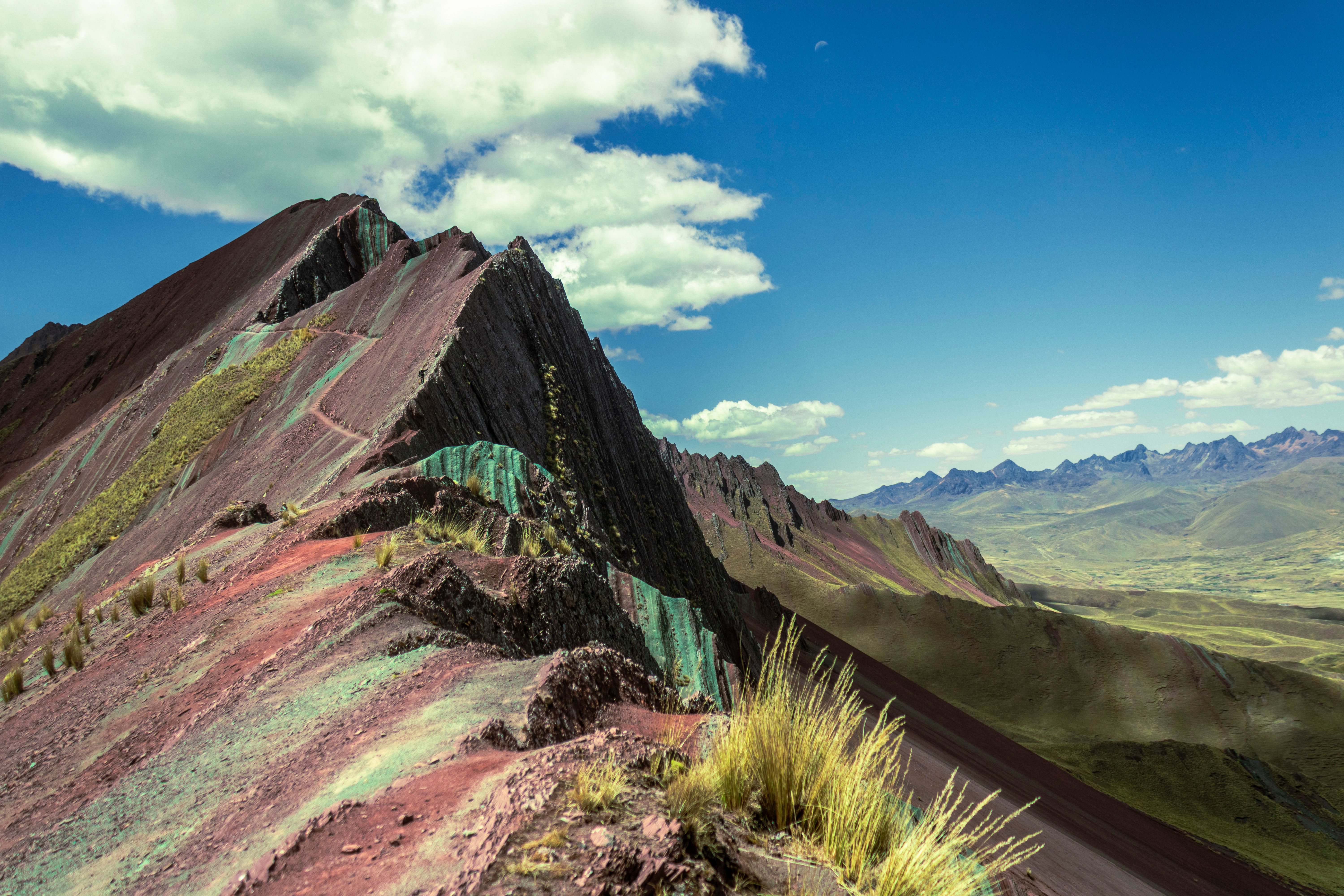 Breathtaking Landscape Of The Rainbow-Colored Slopes Of Vinicunca Mountain In Peru Under A Blue Sky.
