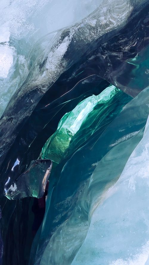 Free A detailed close-up of vibrant blue and green ice formation. Captured in Cusco, Peru. Stock Photo