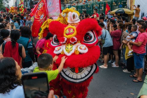 Free A lively lion dance performance captivates a crowd in Ho Chi Minh City during a festival celebration. Stock Photo