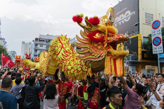 Colorful dragon dance performance in Ho Chi Minh City, Vietnam, celebrating cultural tradition.