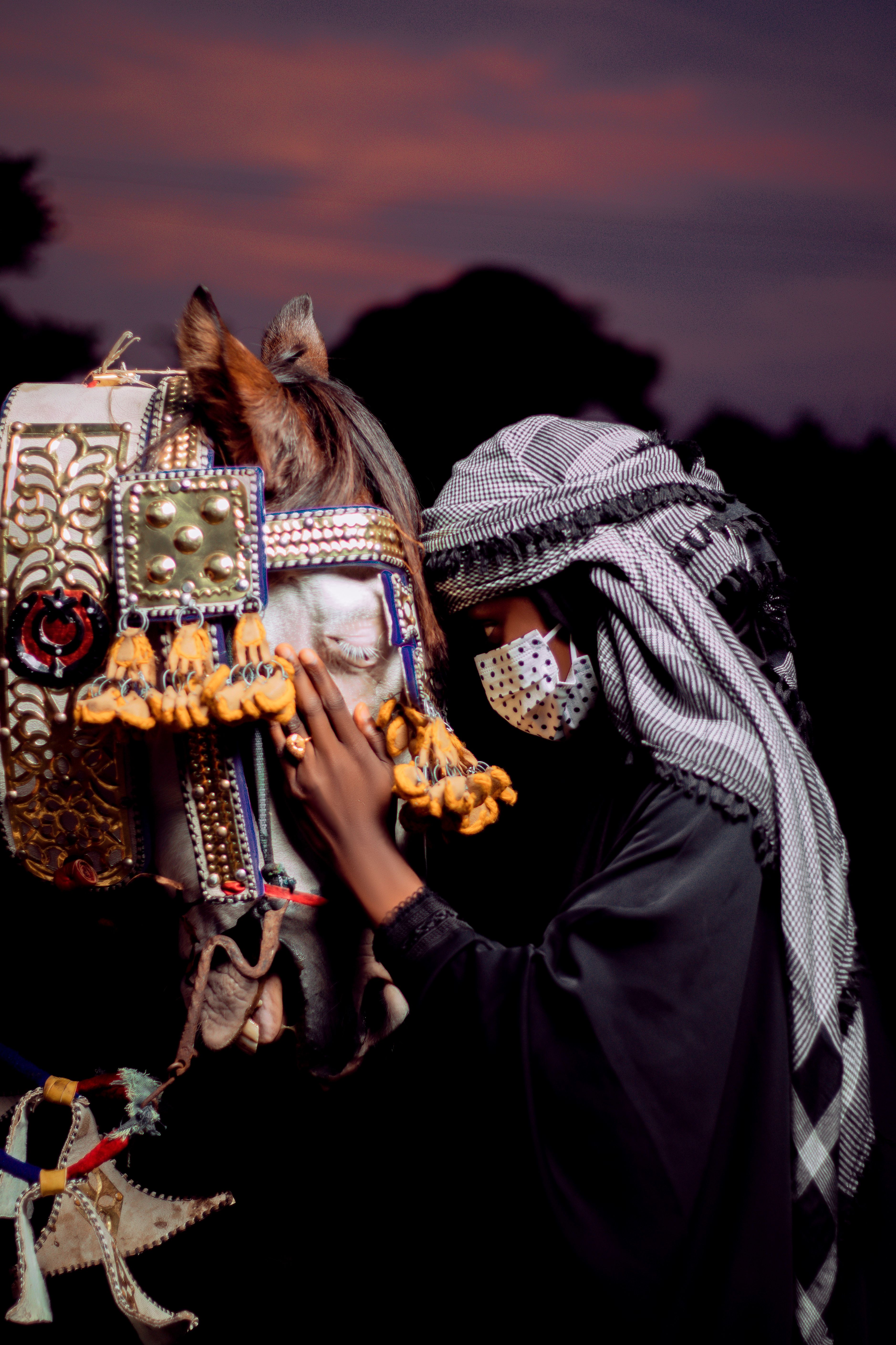 Traditional Attire with Decorated Horse at Sunset · Free Stock Photo