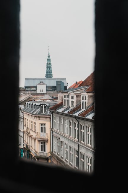 A view of Copenhagen's streets and historic architecture on an overcast day.