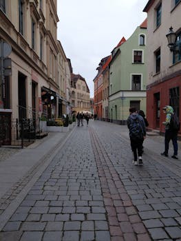 A picturesque European street lined with colorful historic buildings and cobblestones.