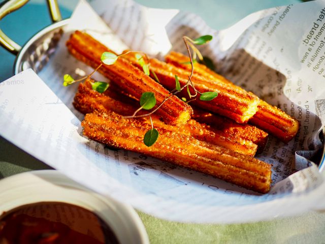 Golden churros with cinnamon sugar served with chocolate sauce. Perfect dessert snack.