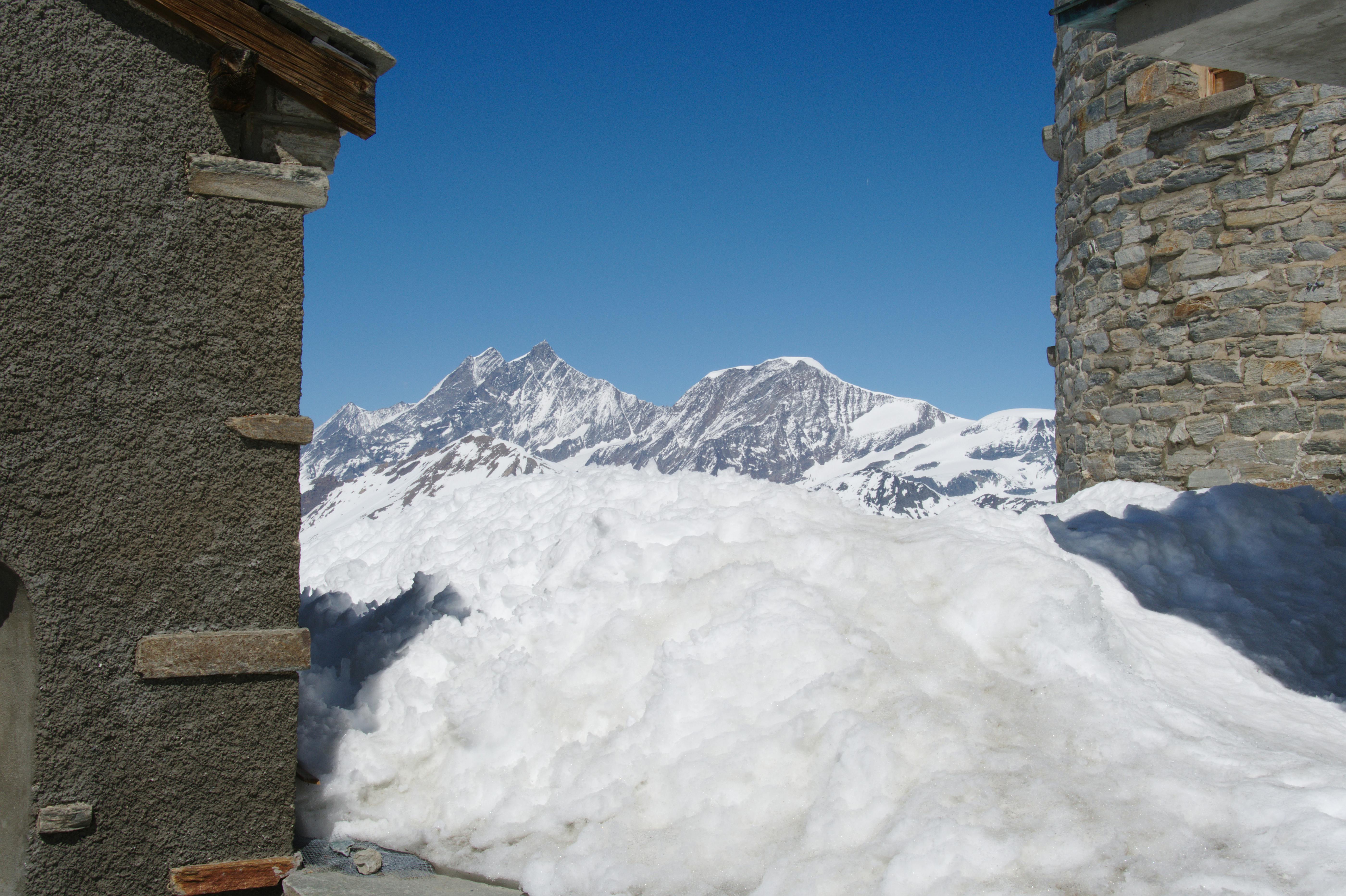 Breathtaking view of the snow-capped Matterhorn between alpine huts on Gornergrat, Switzerland.