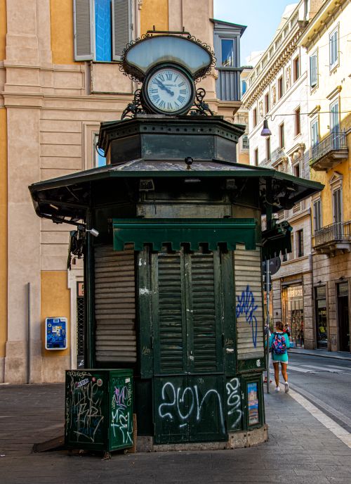 Free An ancient clock tower kiosk with graffiti in a European city street. Stock Photo
