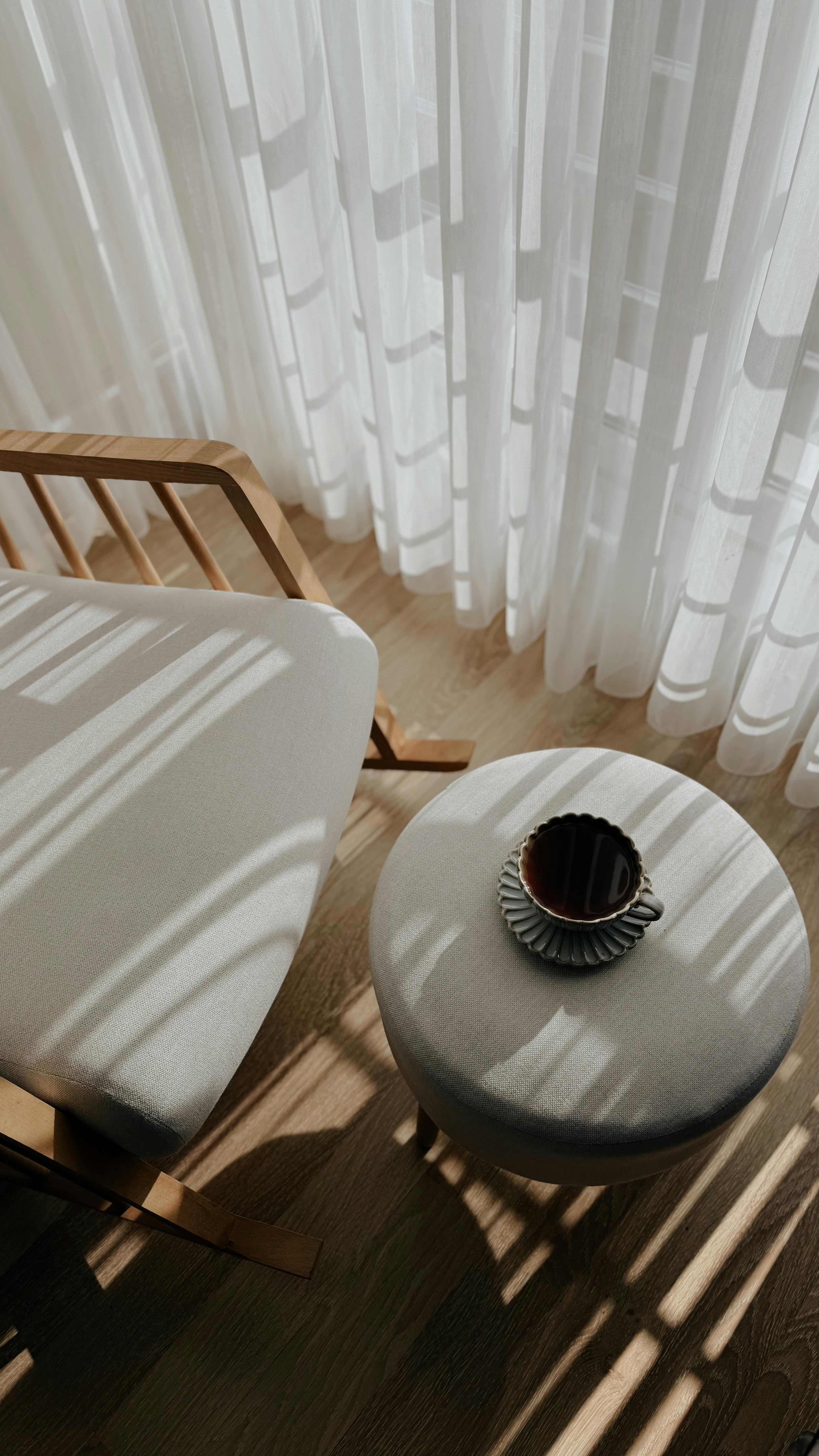 Warm sunlight casts shadows in a cozy, minimalist interior.
