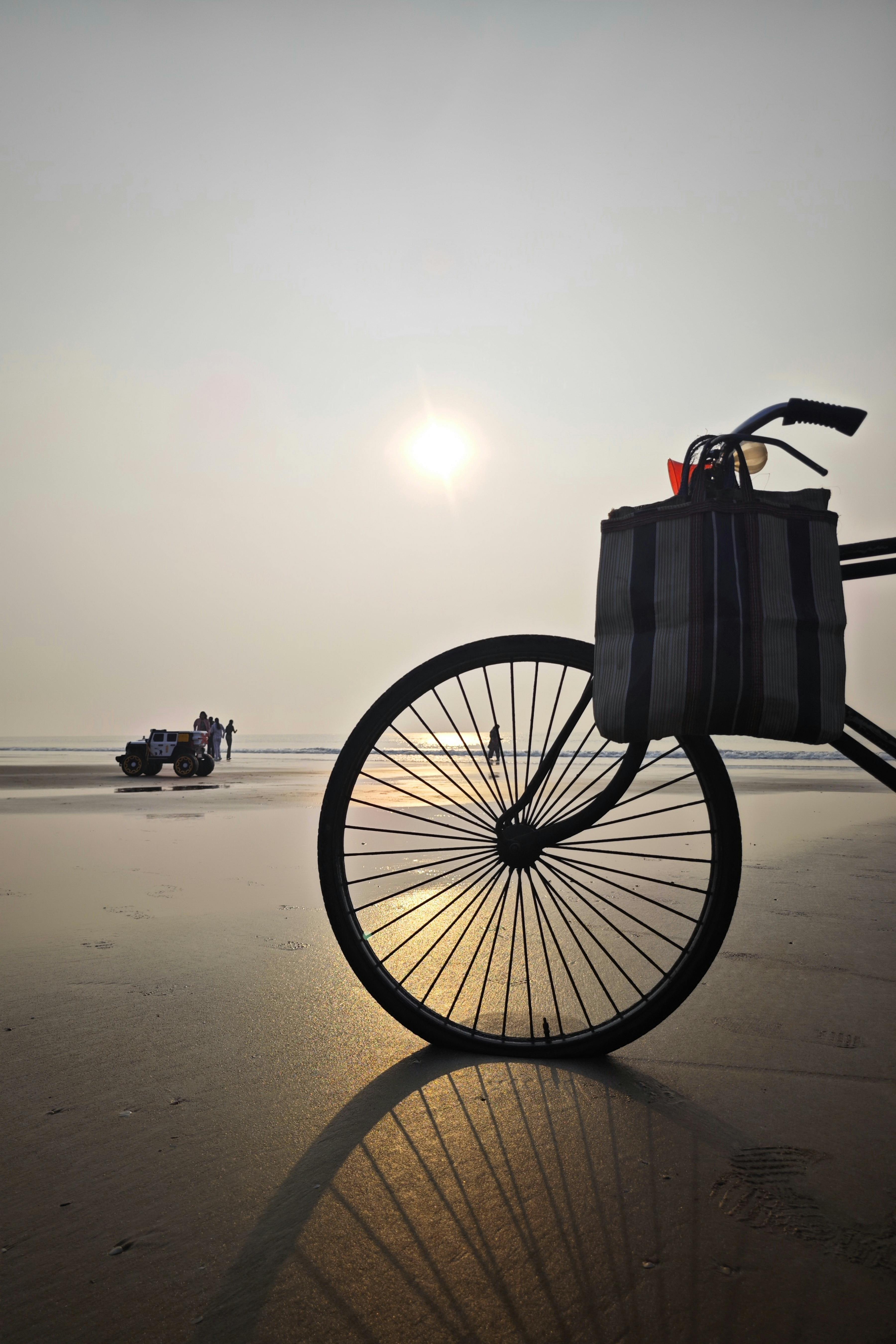 A peaceful sunrise beach scene in Mandarmani, India featuring a bicycle on the shoreline, capturing the natural beauty.