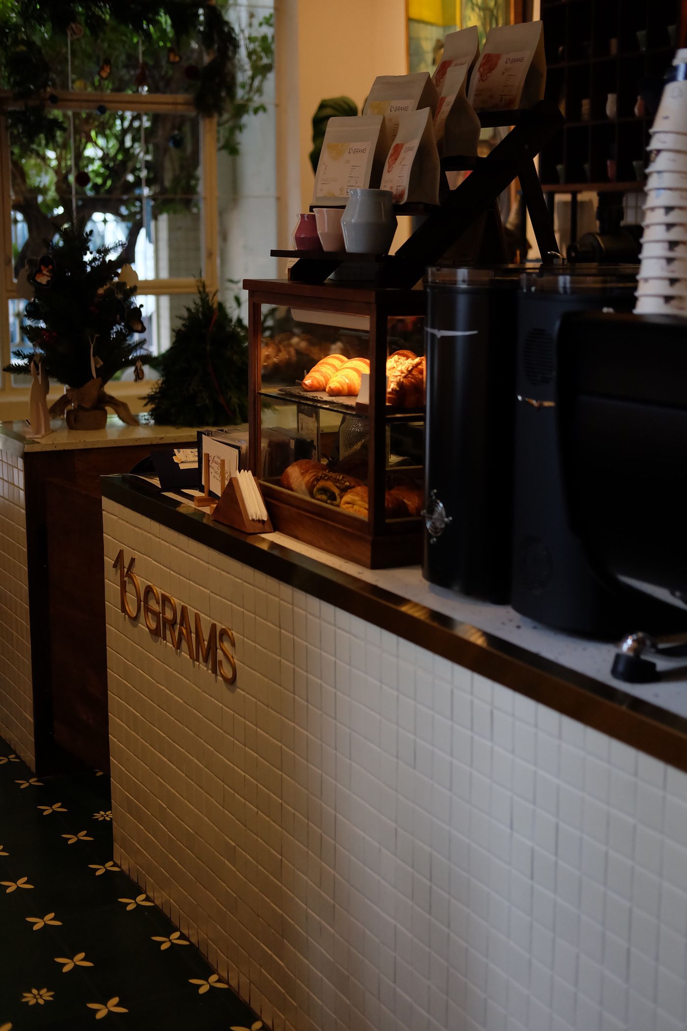 Warm coffee shop counter with fresh pastries on display