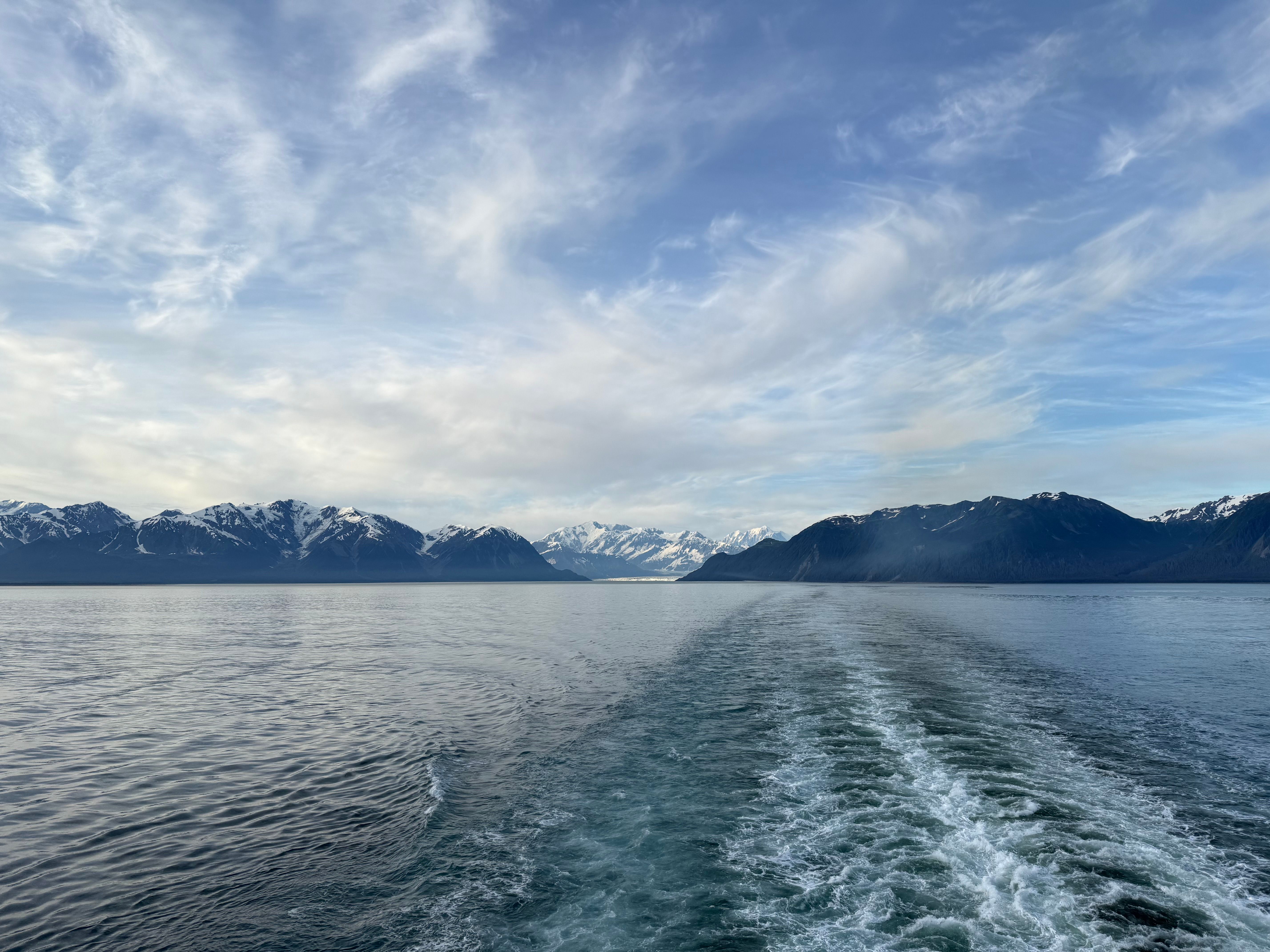 Unforgettable 4 Course Dinner Cruise plus Eco Tour on Luxury Yacht in Sitka Review 2026 - A breathtaking view from the ocean of snow-covered mountains under a vibrant sky.