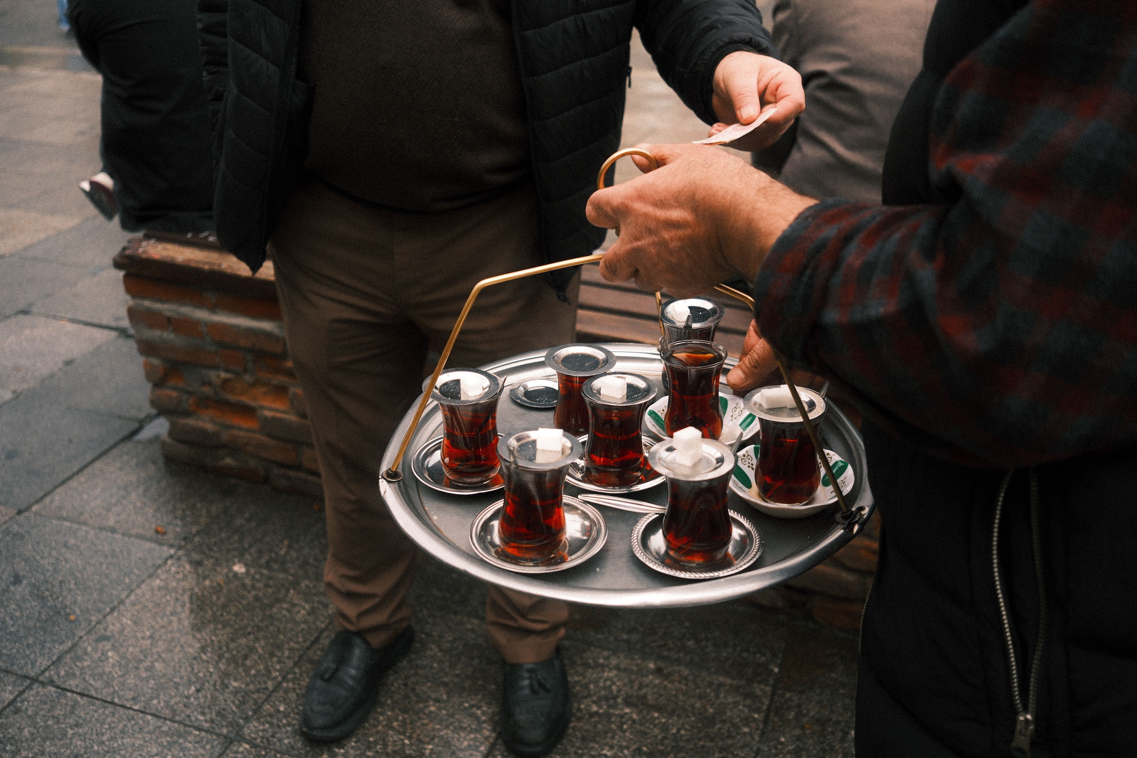 Street Vendor Serving Traditional Turkish Tea · Free Stock Photo