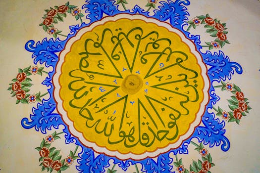 Colorful Islamic ceiling art featuring detailed Arabic calligraphy and floral motifs.