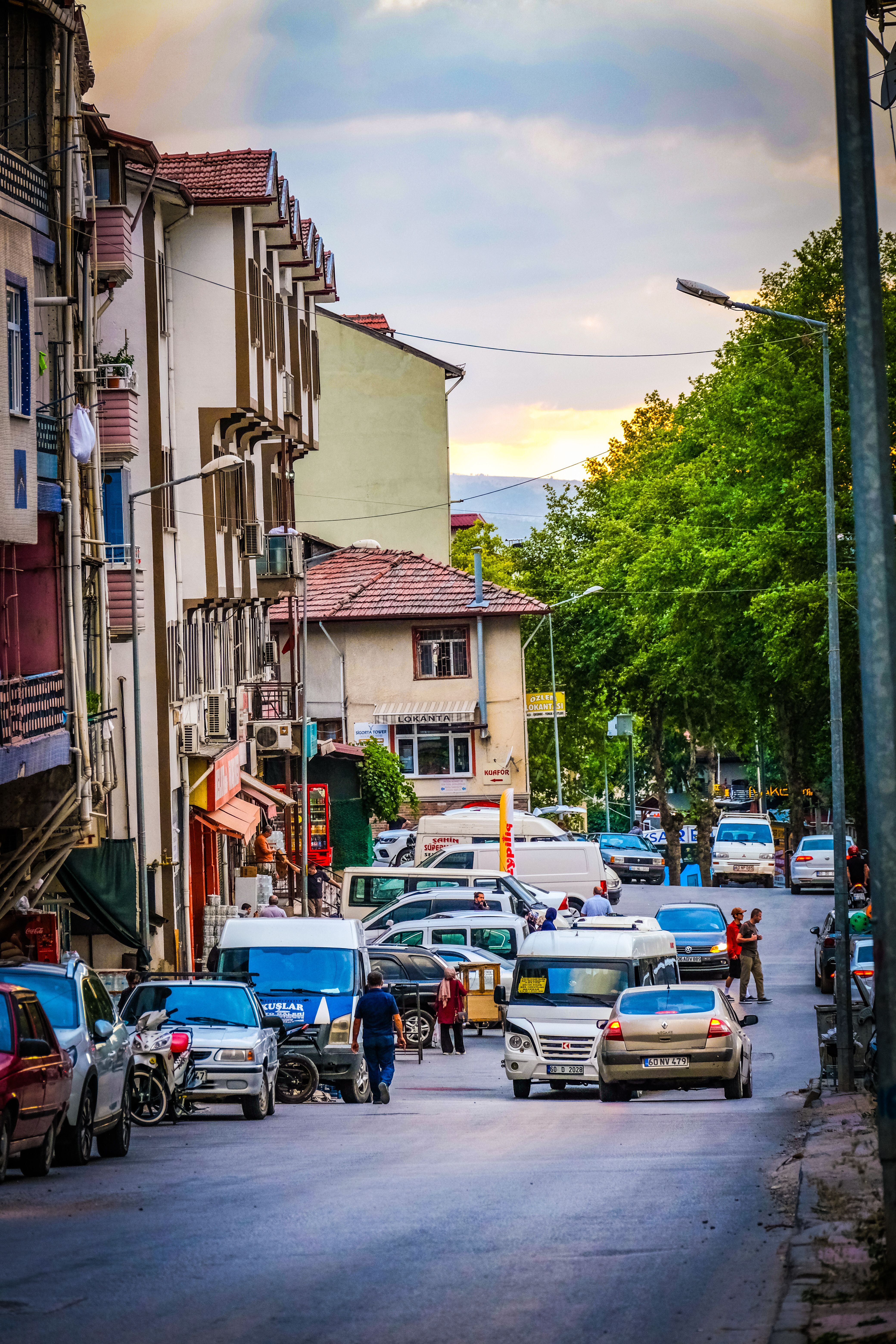 Busy Urban Street at Dusk with Cars and People · Free Stock Photo