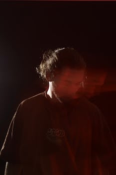 A creative artistic portrait capturing a blurred silhouette of a person in a meditative pose.